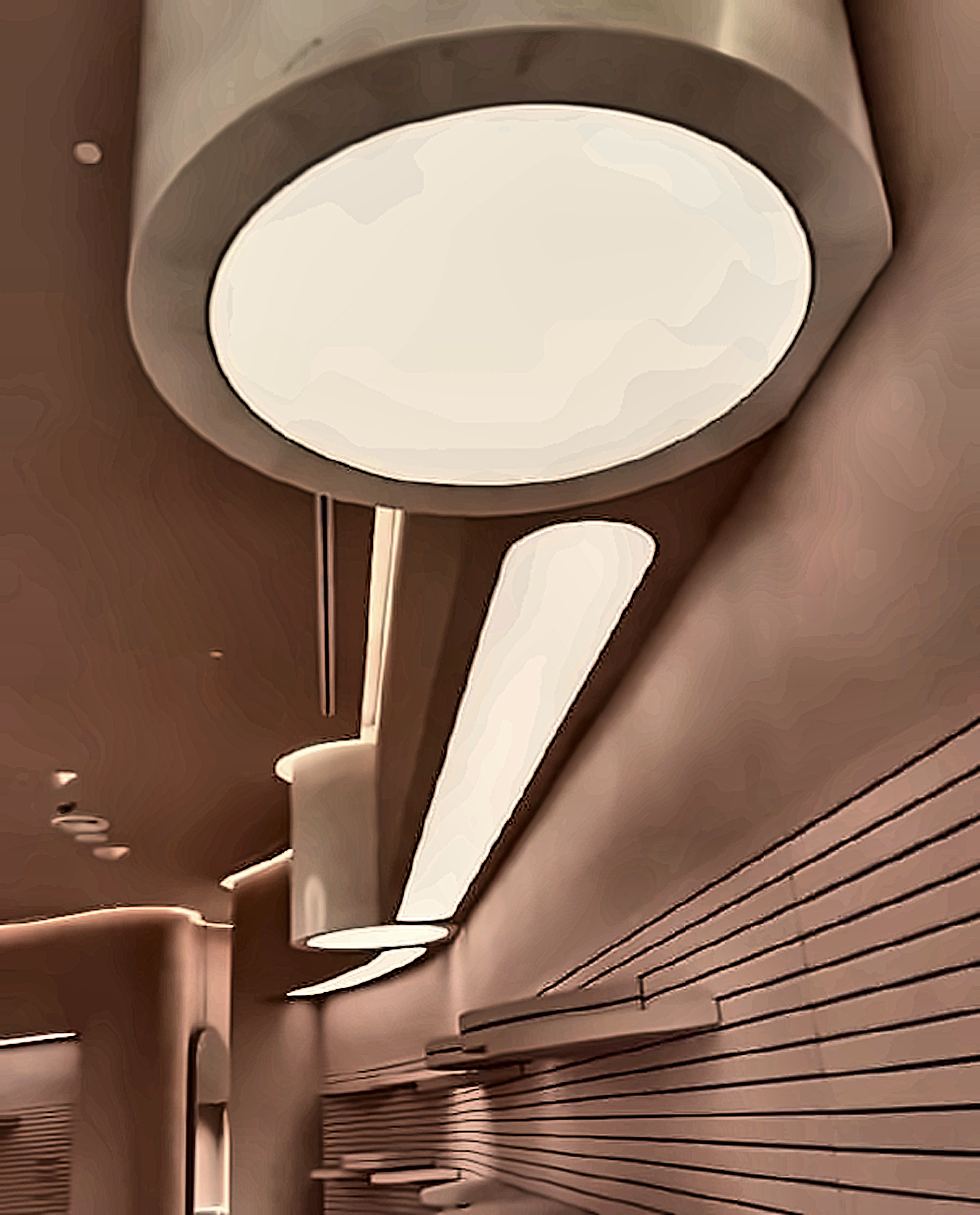 A close detail of a luminaire against a ribbed wall finish