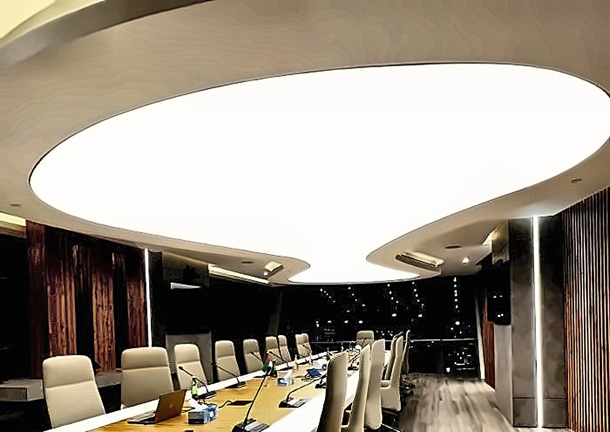 A boardroom under an illuminated oval stretch ceiling