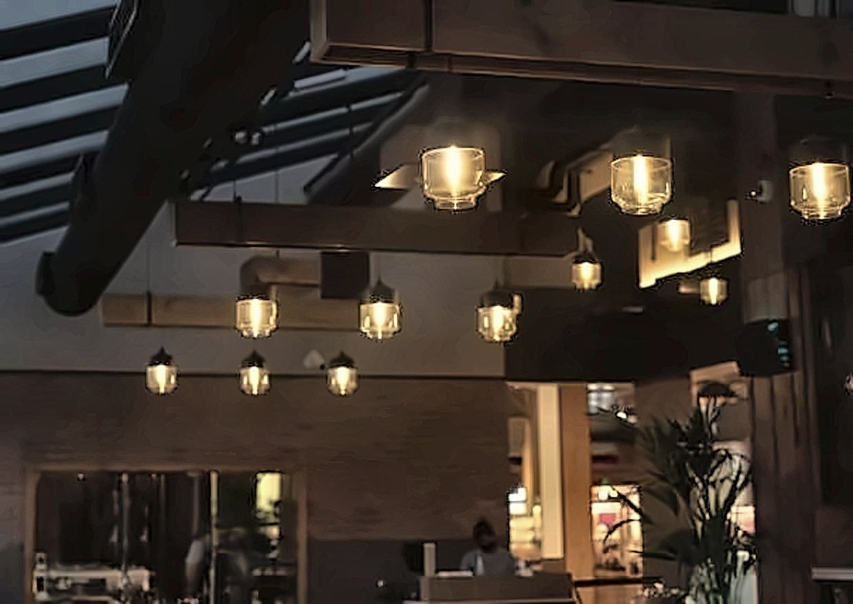 Warm pendant lighting over a restaurant interior